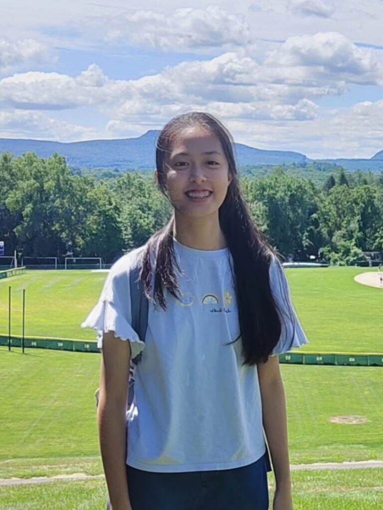 Bonnie Liu in front of a grassy lawn.